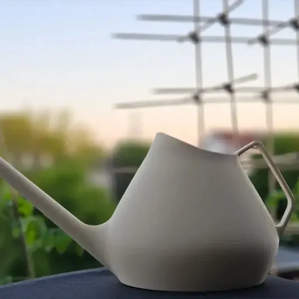 Close-up of two 3D printed watering cans with streamlined design and matte finish, ideal for B2B garden product collections