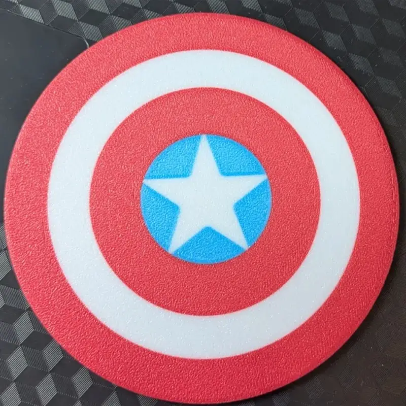 Red, white and blue patriotic shield coaster with star design, shown on wooden surface with China Post packaging elements