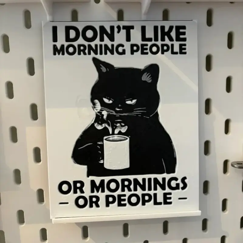 3D printed humorous office wall art featuring grumpy black cat with coffee cup and sarcastic text about mornings