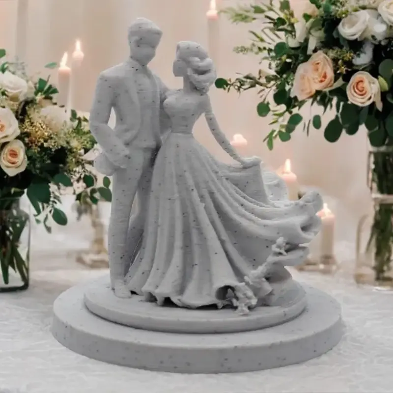 3D printed wedding couple sculpture showing a bride and groom, surrounded by flowers and candles on a festive table