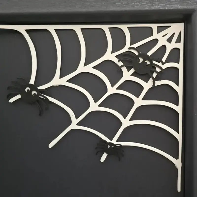 Custom 3D printed spider web decoration with black spiders on a dark background, showcasing intricate web patterns for Halloween decor