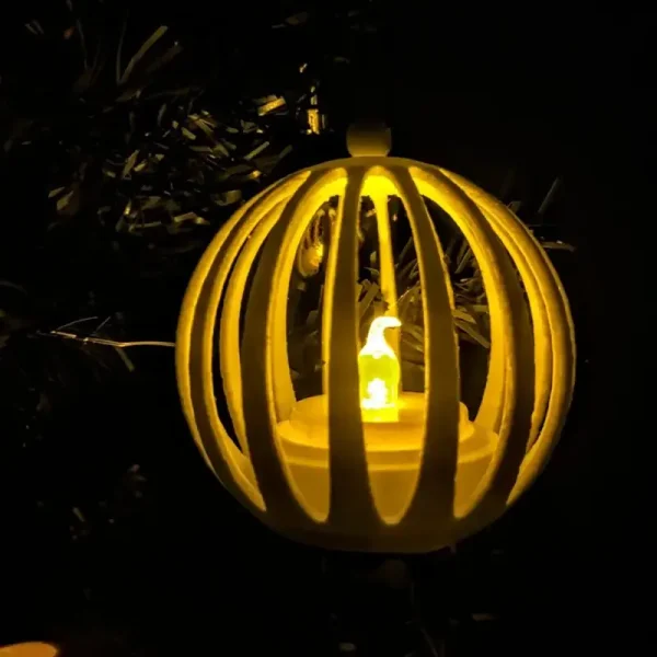 Row of 3D printed Christmas ball lights emitting a soft glow, with intricate designs against a dark background