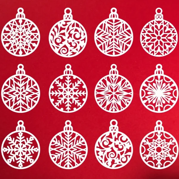 Twelve white 3D printed snowflake ornaments with intricate geometric patterns arranged in grid formation