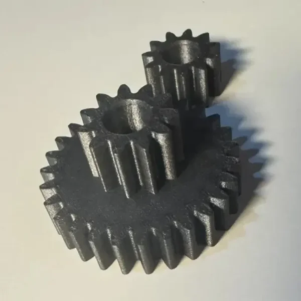 Silver-gray 3D printed precision gear assembly showing interlocking teeth on white background