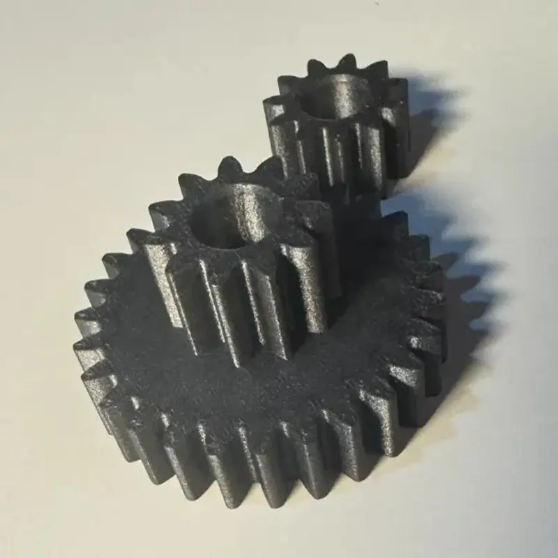 Silver-gray 3D printed precision gear assembly showing interlocking teeth on white background