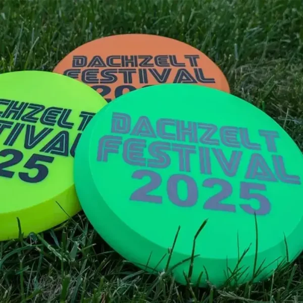 Close-up of premium 3D printed flying discs featuring event branding for B2B clients