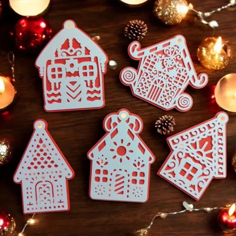 Set of five white and red 3D printed gingerbread house ornaments with intricate cut-out designs, displayed with candles and pinecones on wooden table