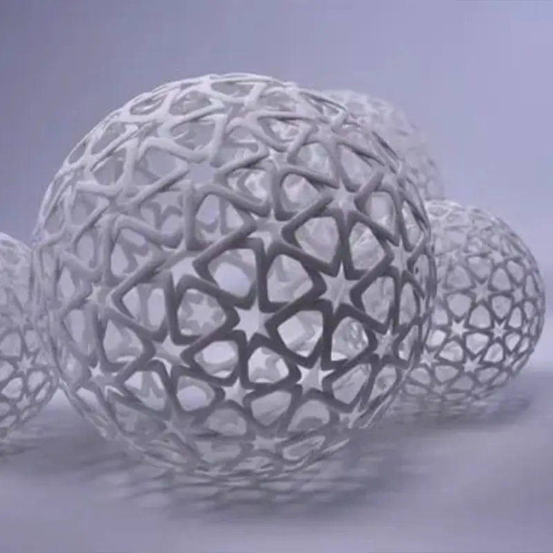 Set of four 3D printed festive sphere ornaments with intricate star patterns, semi-transparent white finish on gray background