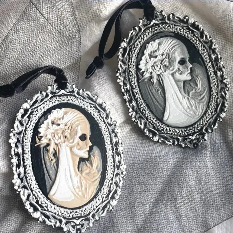 Close-up view of Gothic embossed adornment featuring detailed skull motif and floral patterns in black finish