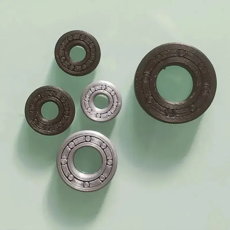 Set of 3D printed precision engineered bearings in various sizes on neutral background