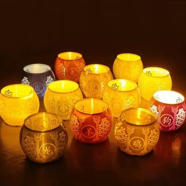 Set of 3D printed Chinese zodiac lantern shades featuring all 12 animals, glowing warmly on dark wooden surface