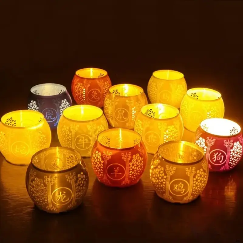 Set of 3D printed Chinese zodiac lantern shades featuring all 12 animals, glowing warmly on dark wooden surface