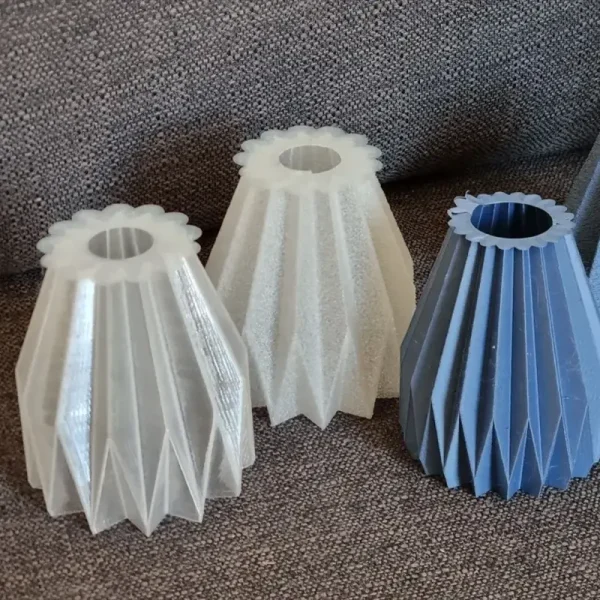 Close-up view of intricately designed bespoke 3D printed light bulb covers, showcasing detailed textures and patterns for B2B clients