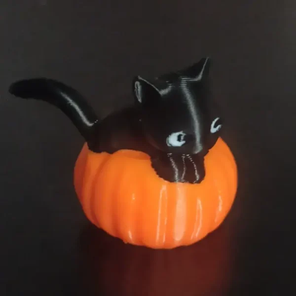 Close-up of black cat and orange pumpkin 3D printed ornaments, perfect for adding a festive touch to retail and hospitality spaces