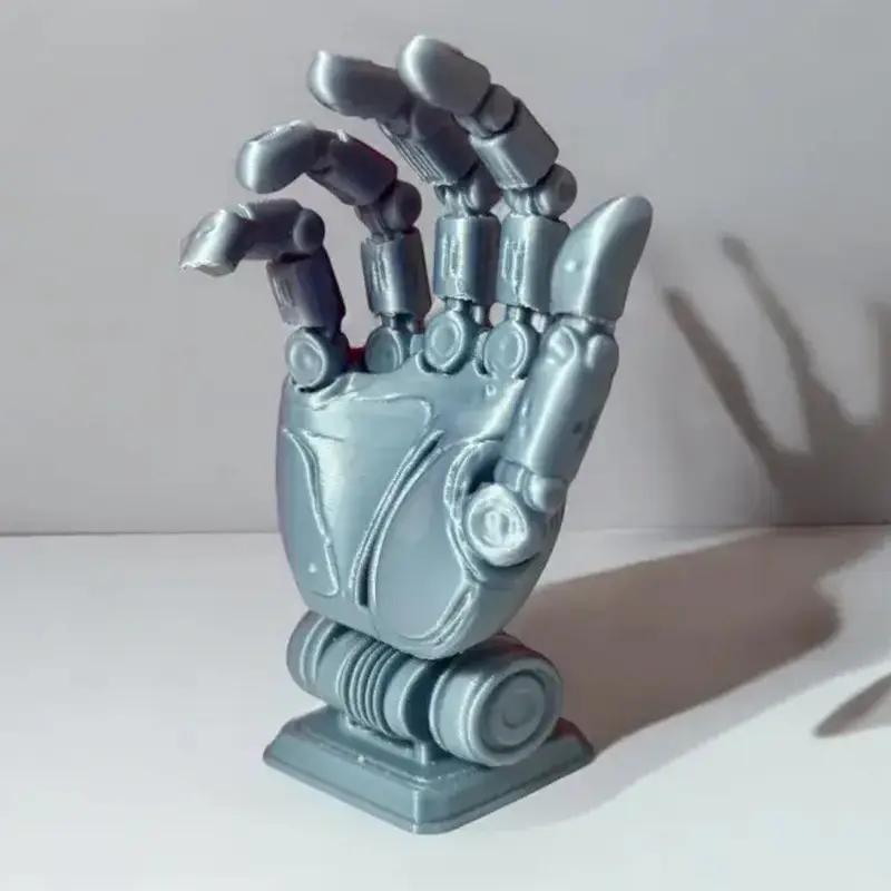 Custom 3D printed robotic hand sculpture showing intricate mechanical details and metallic finish for B2B clients