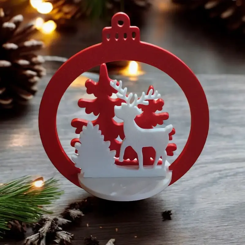 Red and white 3D printed deer ornament with snowflakes and trees featuring "Merry Christmas" text on wooden surface