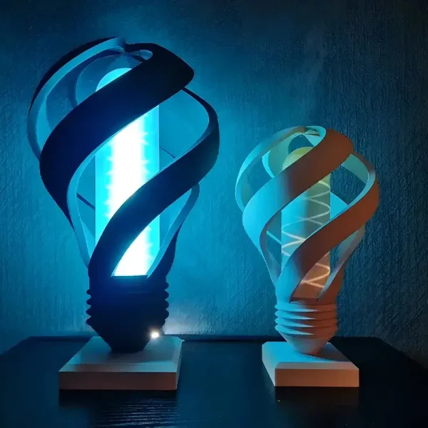 A custom 3D printed lamp cover with intricate blue swirl designs, emitting a soft blue light in a dark setting