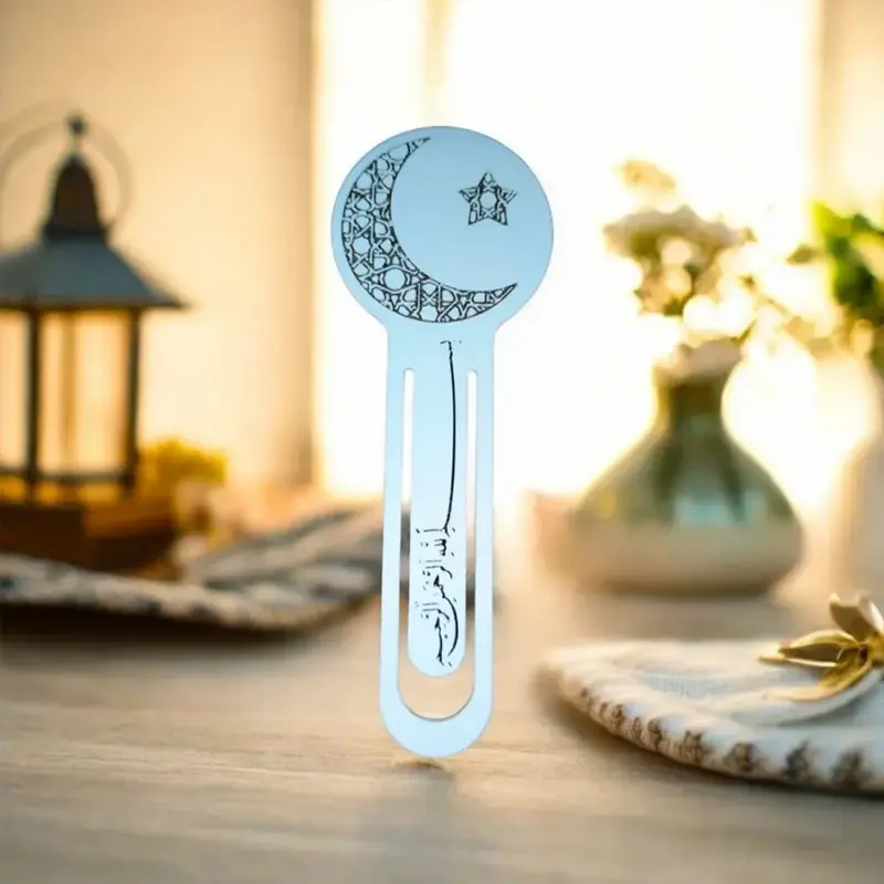 Slender Islamic-themed bookmark featuring crescent moon and star motif, standing upright on wooden surface