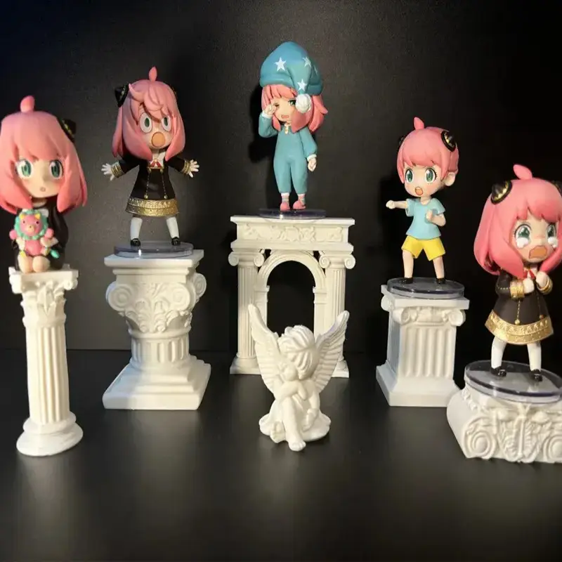 Colorful anime-style girl figurines displayed on white Roman column pedestals with classical designs