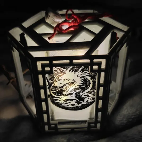 Artisanal 3D printed Chinese lantern featuring intricate dragon motif and hexagonal design with traditional red string for hanging