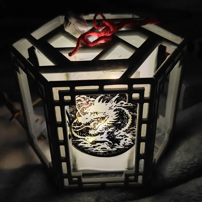 Artisanal 3D printed Chinese lantern featuring intricate dragon motif and hexagonal design with traditional red string for hanging