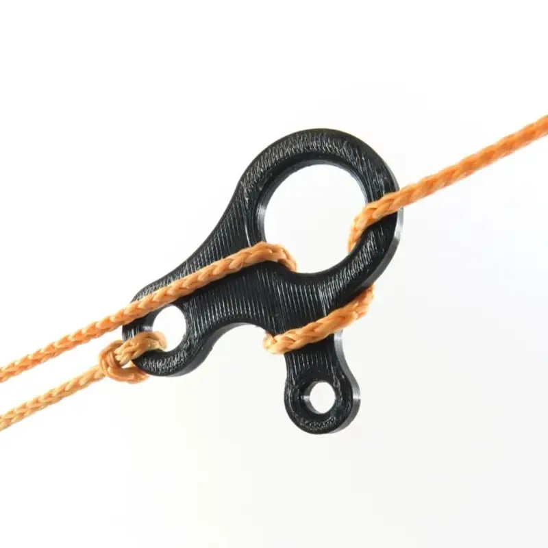 Black 3D printed precision tensioning system with orange components, demonstrating rope engagement and tension control mechanism