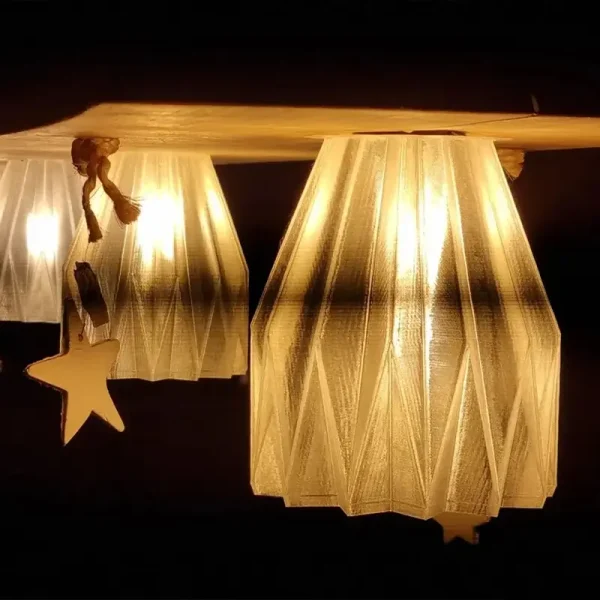 Bespoke 3D printed light bulb covers emitting a soft warm glow, hanging from a wooden beam in a commercial setting