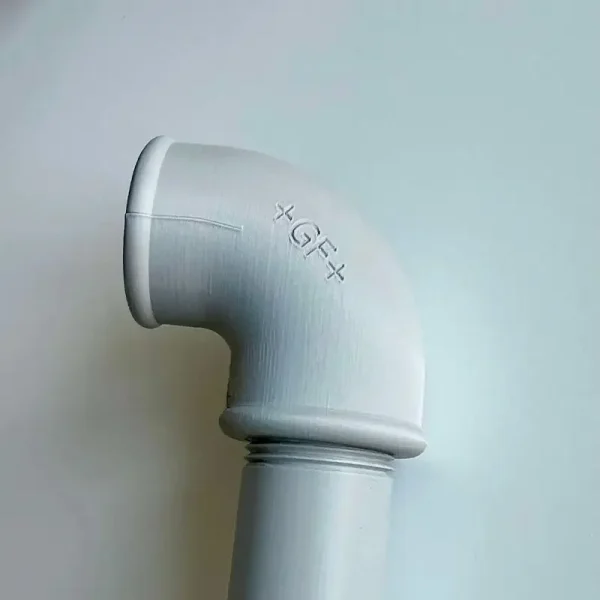 Detailed view of precision angled pipe connector showing smooth curvature and quality markings