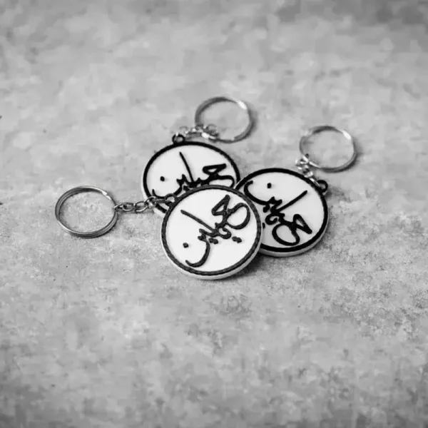 Close-up of commemorative Arabic medallions showing detailed script work for B2B clients