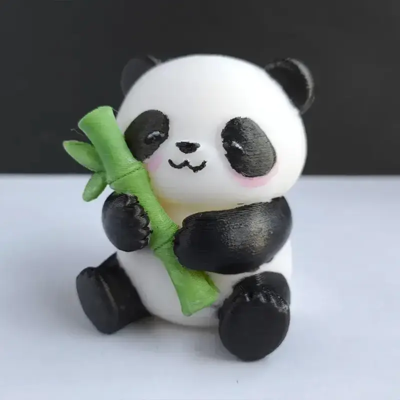 Artisanal 3D printed panda sculpture with black-and-white coloring, holding green bamboo, displayed on a neutral background for B2B clients