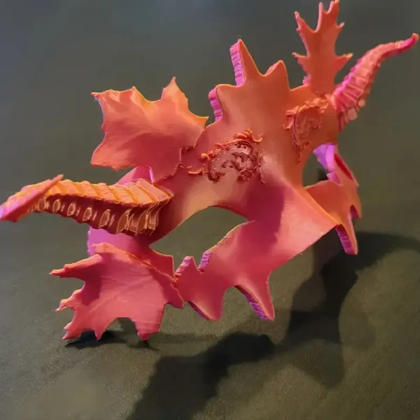 Elegant 3D-printed Halloween ball mask featuring pink and orange floral patterns, displayed on a dark background for B2B clients