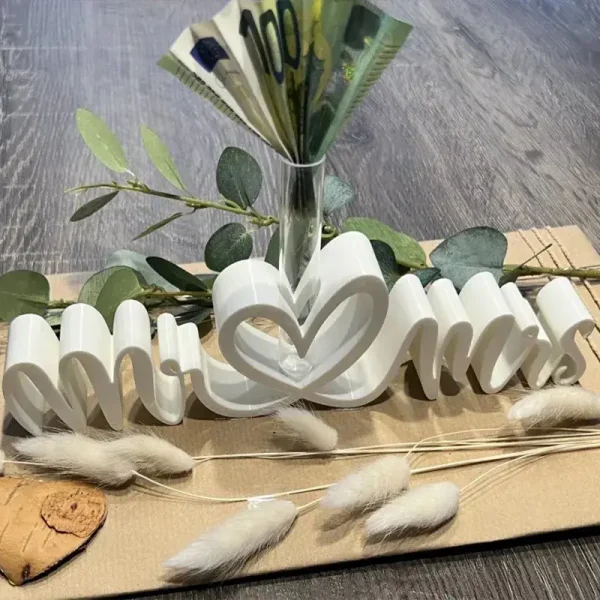 White 3D printed Mr & Mrs heart-shaped vase holding 100 Euro notes with eucalyptus leaves and pampas grass decoration