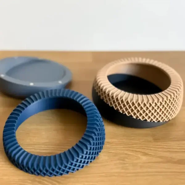 Set of two 3D printed coaster holders in brown and blue colors, showcasing grid patterns for B2B tabletop solutions
