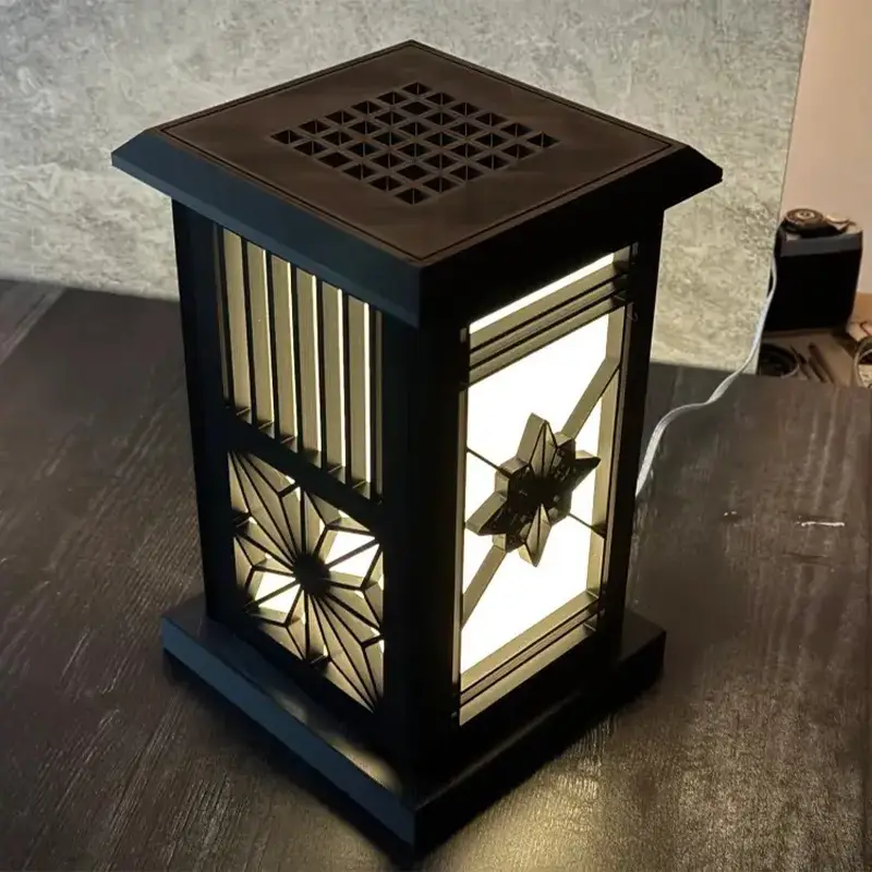 Artisanal 3D printed geometric lantern with square base and intricate patterns emitting warm light for B2B clients