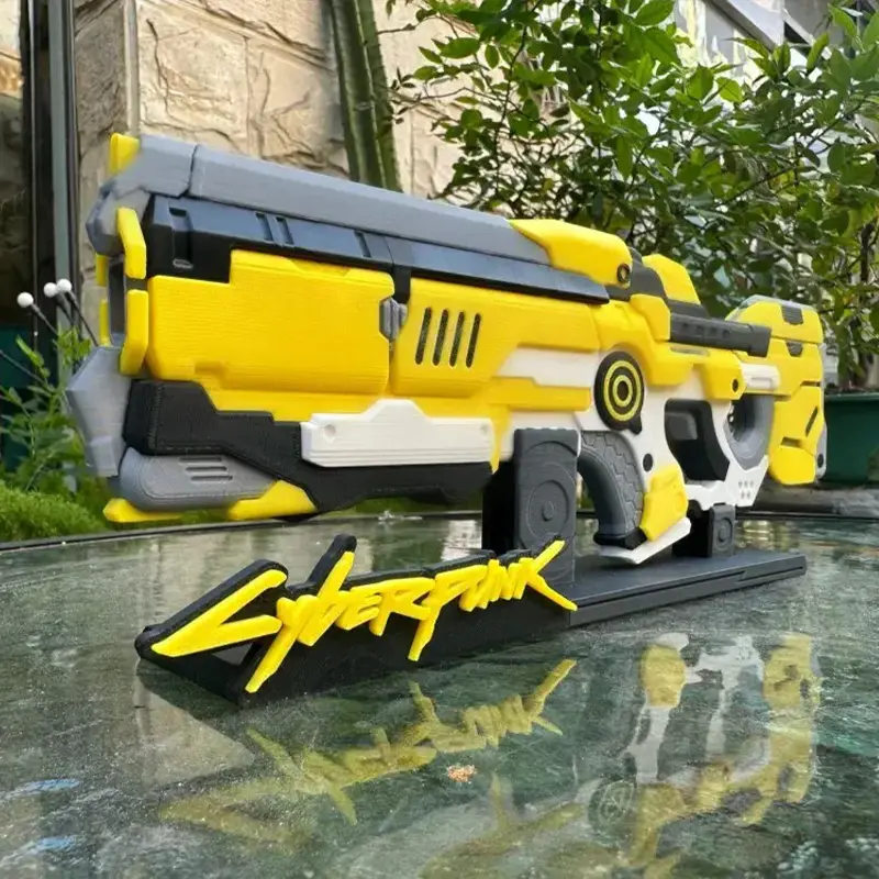 Custom 3D printed Cyperfunk firearm replica showing yellow and black color scheme with detailed branding