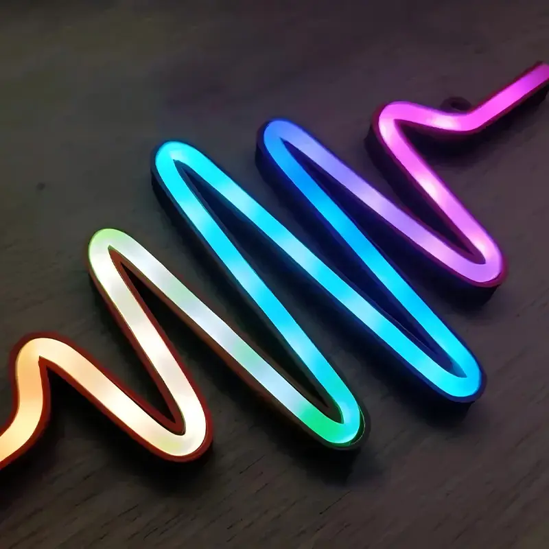 Vibrant wave-form LED light strips in orange, pink, blue and green colors arranged in dynamic patterns on dark background