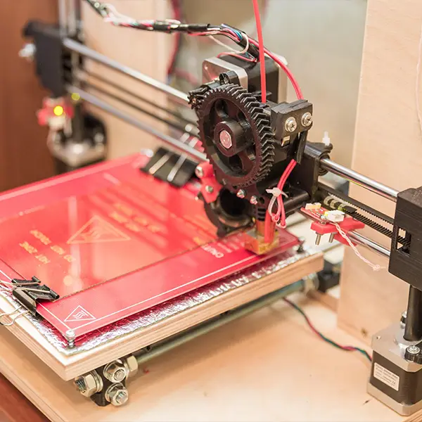 A side-by-side diagram comparing 3D printing (building a complex gear layer-by-layer) and CNC machining (carving a simple gear from a solid block), illustrating the fundamental difference between the two processes.