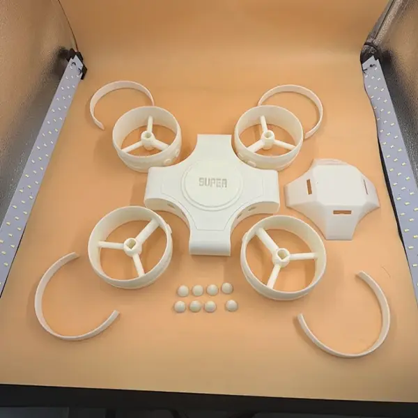 A side-by-side comparison showing a CAD design on a laptop screen next to a physical, multi-part FDM prototype being assembled, illustrating the rapid turnaround time of industrial FDM printing.
